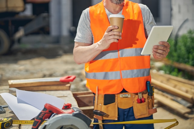 A contractor reviewing project details on a tablet